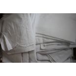 A large assortment of white work textiles,