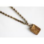 A late Victorian locket and chain, the decorative link chain with applied pad stamped '9c',