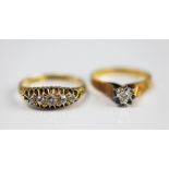 An 18ct gold and diamond solitaire ring, illusion set and within textured shoulders and plain hoop,