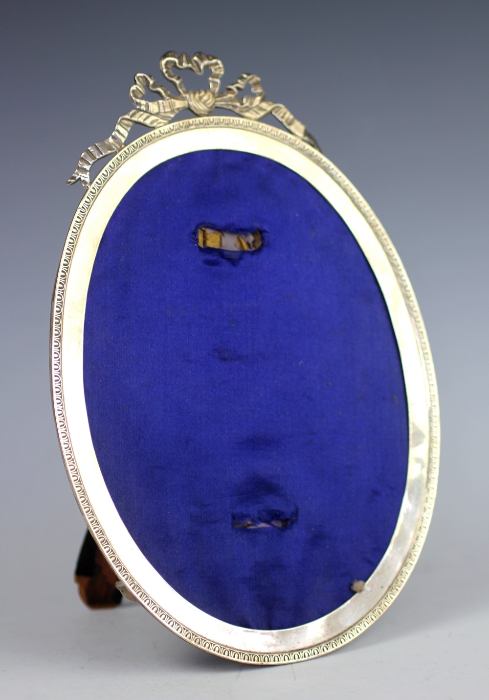 An Edwardian oval silver mounted photograph frame, Stokes & Ireland Ltd, Chester 1908,