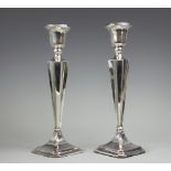 A pair of George V silver candlesticks, Chester 1923, of canted square form,