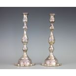 A pair of George V silver candlesticks, London 1925, each with turned stems and garland decoration,