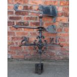 A wrought iron weather vane modelled with a crouching cat and a mouse, with scroll detailing,