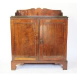 A Waring and Gillow mahogany low cabinet, with three quarter gallery back and two cupboard doors,