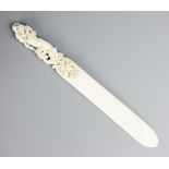 A Victorian carved ivory page tuner, the handle worked as a cornucopia of flowers,