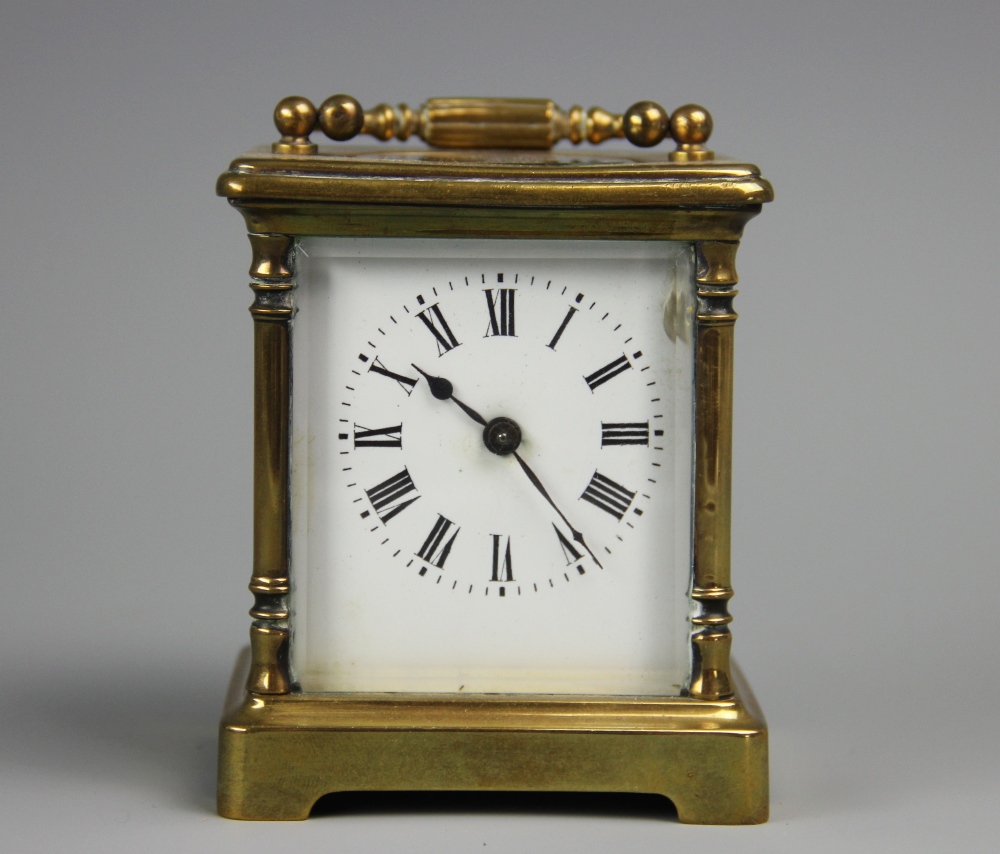 A late 19th century French brass carriage time piece, Roman numeral enamel dial,