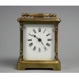 A late 19th century French brass carriage time piece, Roman numeral enamel dial,