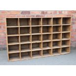 A pine bank of thirty five shelves,