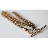 A 9ct gold bracelet (converted from an albert chain) the uniform curb link chain with attached T