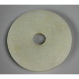 A Chinese carved jade Bi disc, carved with an archaic design, 5.