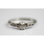 A diamond solitaire ring, the central diamond (measuring approx 0.