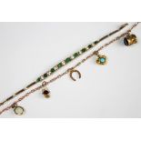 A slender 9ct gold chain bracelet hung with five attached charms, to include an opal set charm,