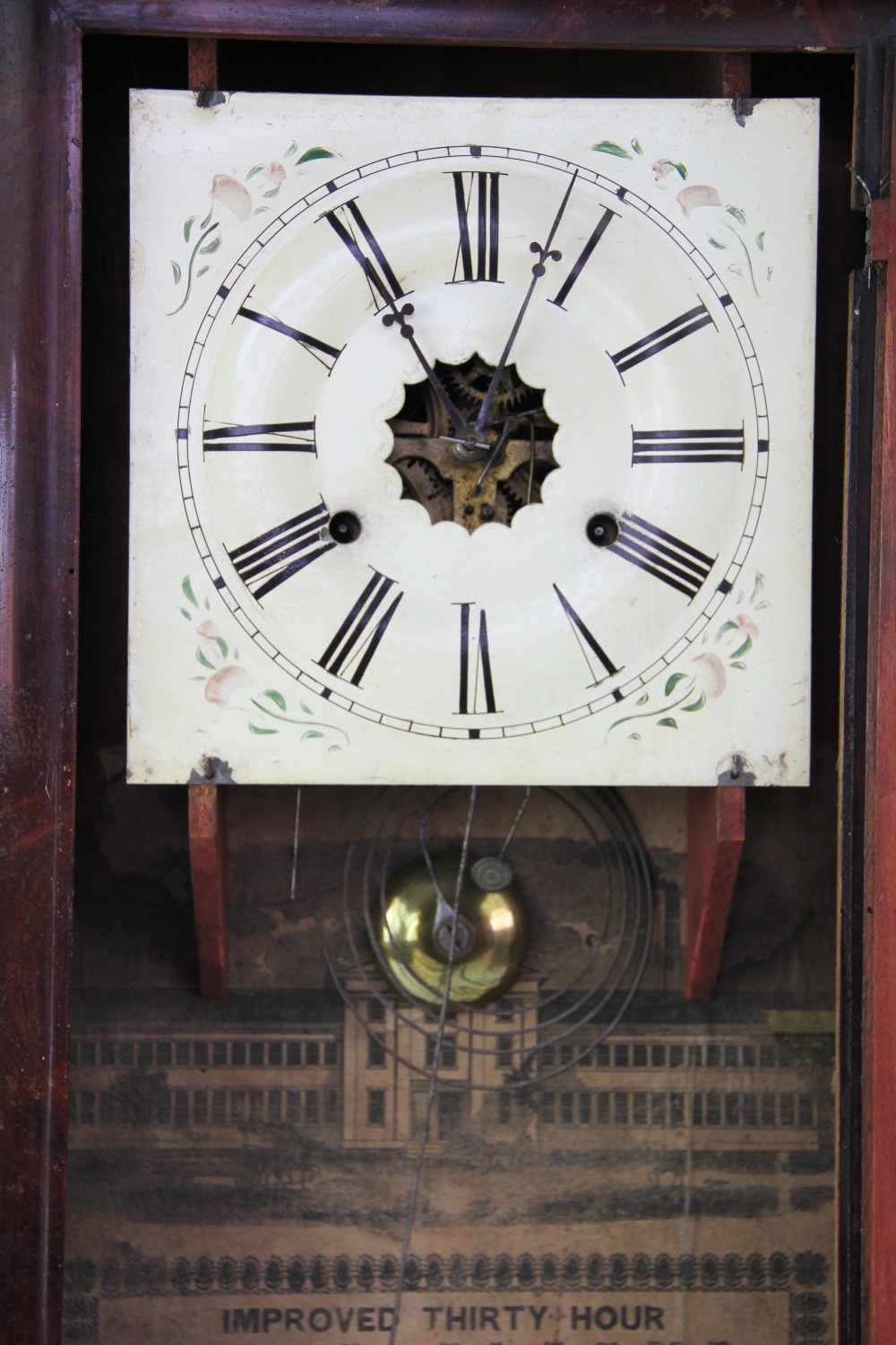 An American walnut wall clock, Roman numeral dial with paper label for E.