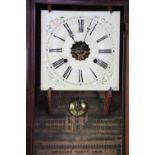 An American walnut wall clock, Roman numeral dial with paper label for E.