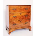 An early 19th century mahogany chest, of three long drawers, on ogee bracket feet,