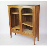 A pair of bespoke crafted walnut cabinets, with two glazed doors and ribbed side panels,