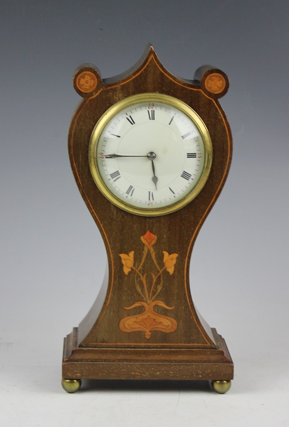 An Edwardian Art Nouveau inlaid mahogany mantel time piece,