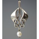 An Art Nouveau style silver pendant in the manner of Archibald Knox suspending a central untested