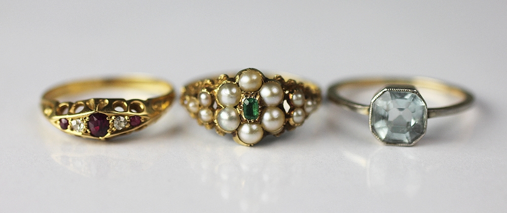A Victorian emerald and pearl set flower cluster ring, with vacant locket back,