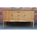 A Gordon Russell walnut sideboard, with an arrangement of three drawers and two cupboard doors,