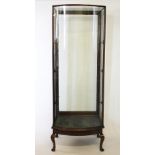 A late Victorian mahogany bow front vintage shop display cabinet on stand, glazed all round,