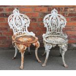 A pair of 19th century style cast iron garden chairs,