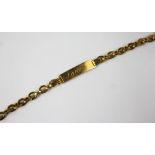 A gold baby's or identity bracelet engraved 'Janet' with attached decorative chain strap and bolt