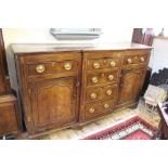 A George III break front oak dresser base,