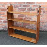 A Victorian walnut hanging shelf, with serpentine side panels,