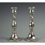 A pair of silver candlesticks, Birmingham 1929, each with turned columns, RegNo.735079, 21.