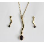 An amethyst and diamond pendant and a matching pair of earrings,