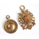 Two 9ct yellow gold fobs, to include; a circular and a shield shaped example,