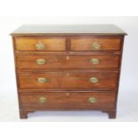 A George III oak chest, on two short and three graduated long drawers on bracket feet,