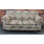 An Edwardian drop end settee, on turned legs,