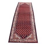 A Persian hand woven wool runner,