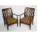 A pair of 1930's vintage beech easy chairs, with pierced fret cut trellis backs,