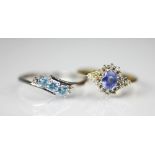 A tanzanite and diamond ring, the central oval tanzanite, with a diamond set surround,