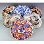 A selection of Japanese Imari plates to include a set of three plates each with pierced rims and