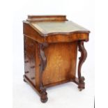 A Victorian inlaid walnut serpentine Davenport, with slope enclosing a fitted interior,