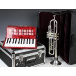A cased Besson 14282 trumpet and mouthpiece along with a cased Chamson accordion (2)