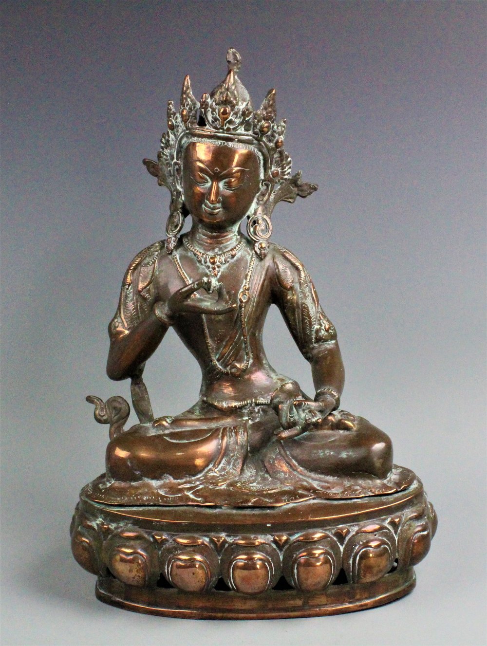A Nepalese/Tibetan bronze sculpture of Vajarasattva, modelled seated with dorje and ghanta,