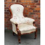 A Victorian carved mahogany salon chair, with spoon shaped back, on turned legs with fitted castors,