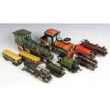An assortment of tin plate clock work locomotives and other trains and carriages,