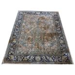 A Persian carpet, worked with a scene of birds and a central vase of flowers in pale colours,