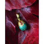 A modern Victor Mayer for Faberge egg pendant, the 18ct gold pendant enamelled in green,