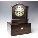 A 1920's walnut eight day mantel clock, with Roman numeral dial and movement striking on two gongs,