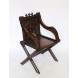 A 1920's carved oak Glastonbury type chair 91cm H