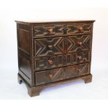 A later 17th century and later oak attic chest, with four fielded long drawers, with turned handles,
