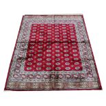 A Kashmir Bokhara pattern rug, worked with a pattern of gulls against a red ground,