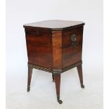 A Regency mahogany cellarette, of canted square form, with brass lion loop handles, on tapered legs,